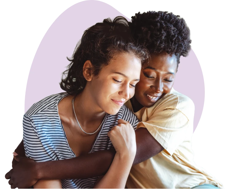 Two women sitting together and embracing