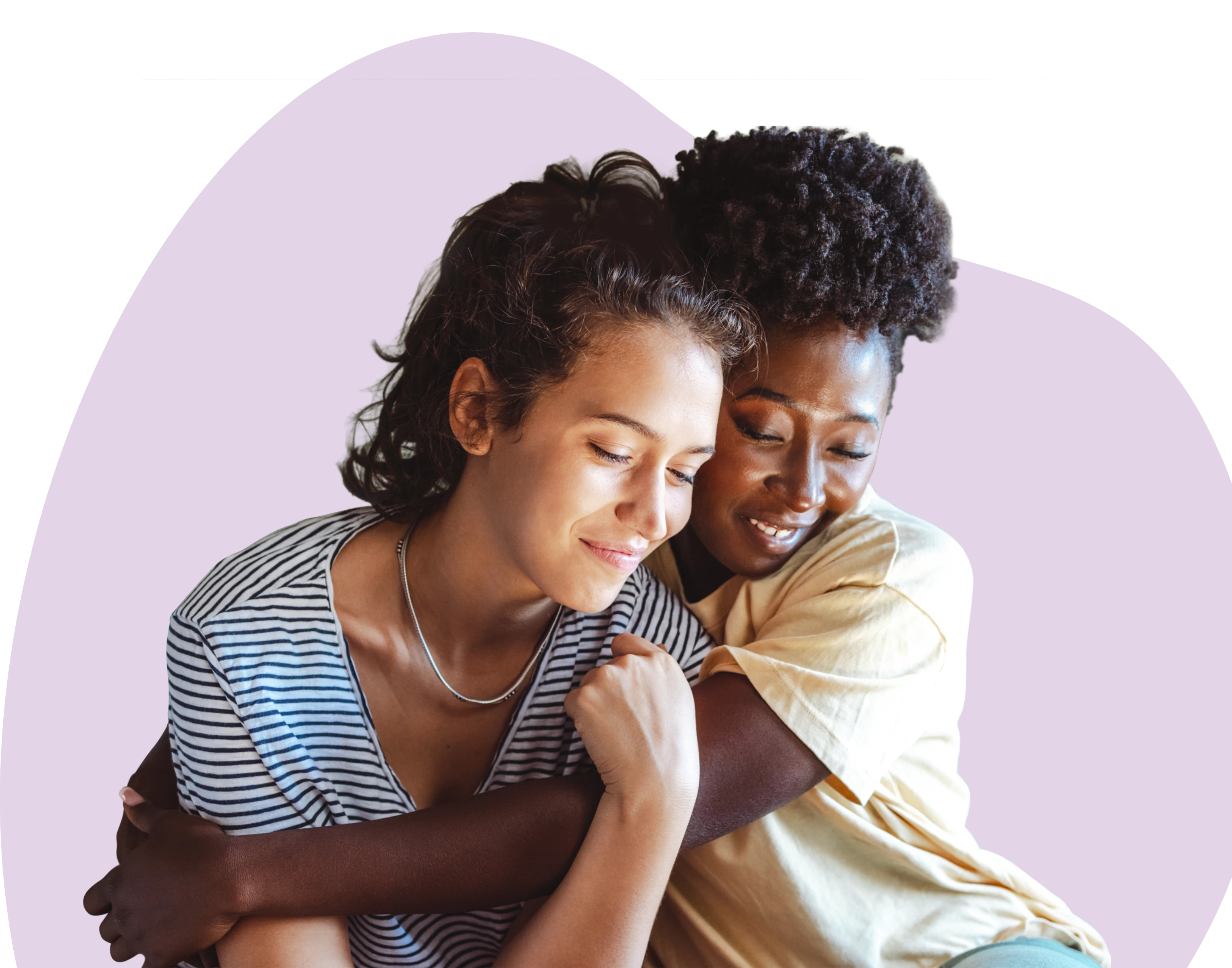 Two women sitting together and embracing